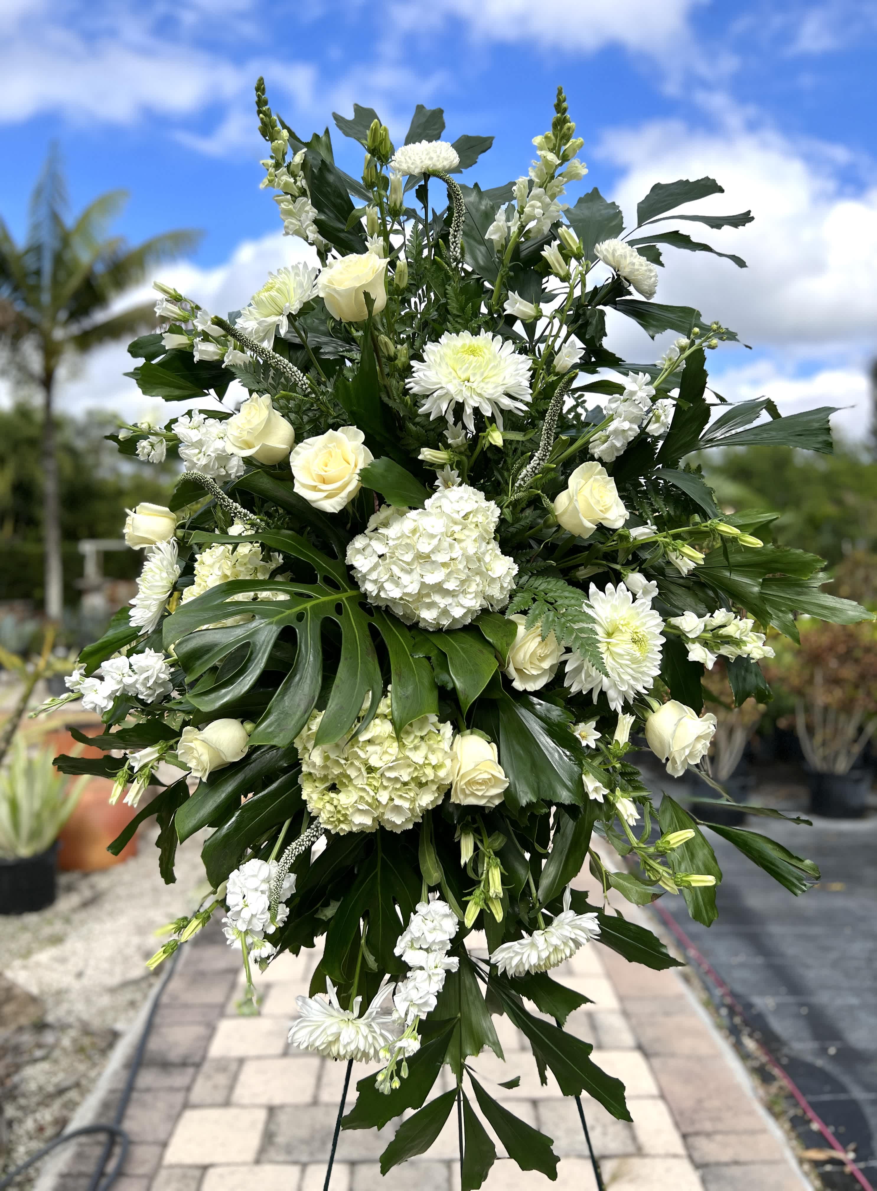 Large white floral standing spray with roses and chrysanthemums
