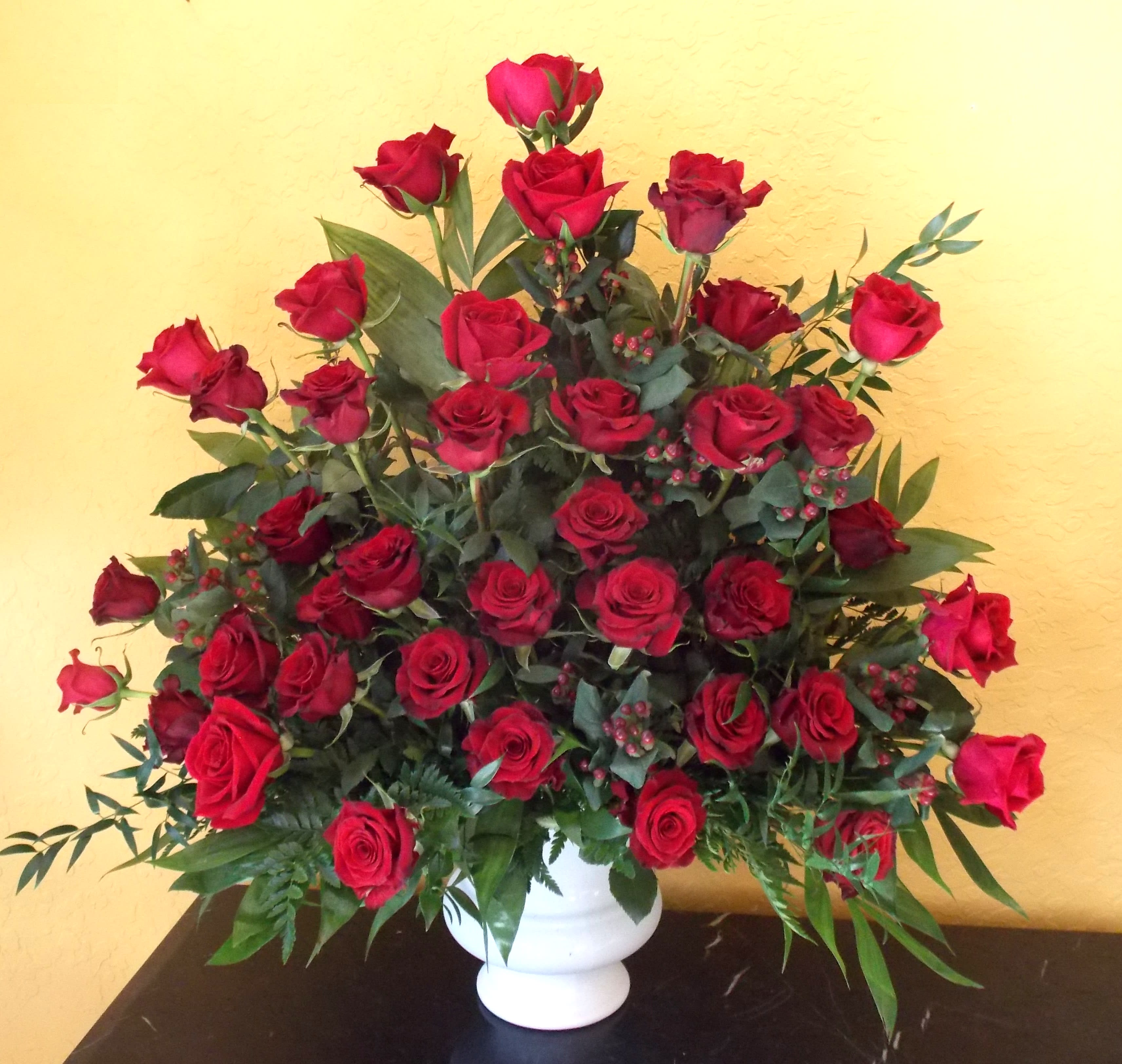 Large bouquet of red roses in a white vase