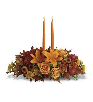 Family Gathering Centerpiece - A fall centerpiece with orange roses, lily's alstromeria, bronze buttons, bronze daisy's, and rust daisy's. Centerpiece includes 2 taper candles.  **Colors of candles may vary but we will sub as similar as possible**