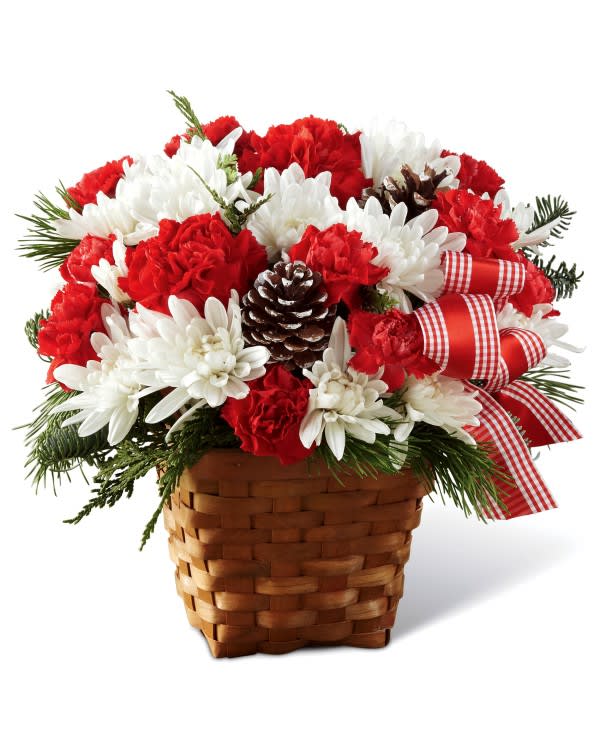 Red and white flowers in a woven basket with a plaid ribbon