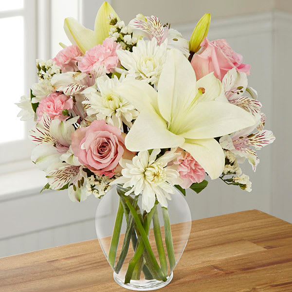 Pink and white mixed bouquet in a clear glass vase