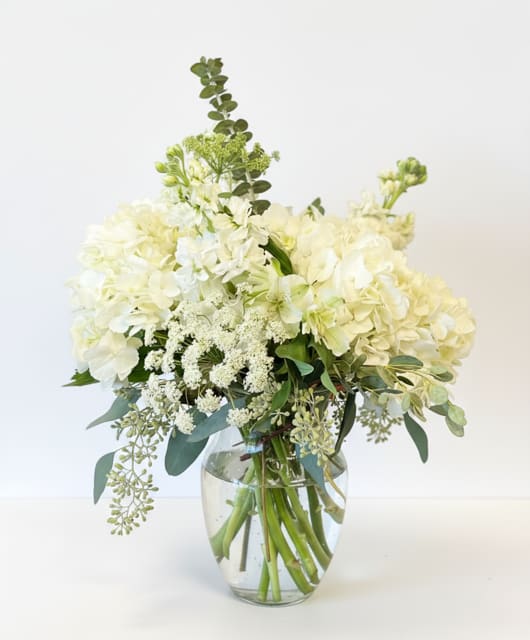 White hydrangea bouquet in a clear glass vase