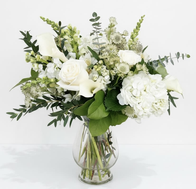 White floral bouquet in a clear glass vase