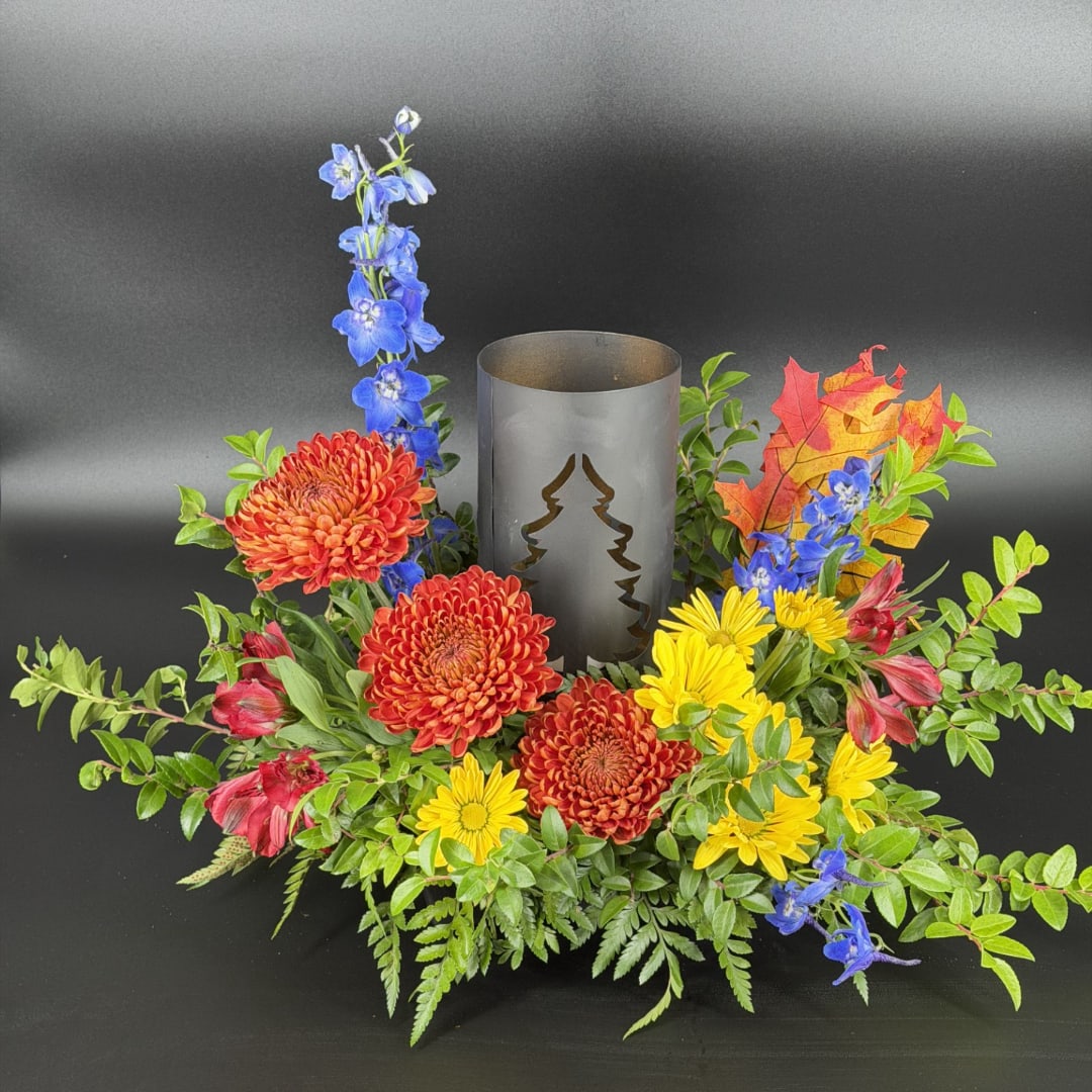 Autumn floral centerpiece with chrysanthemums and a metal candle holder