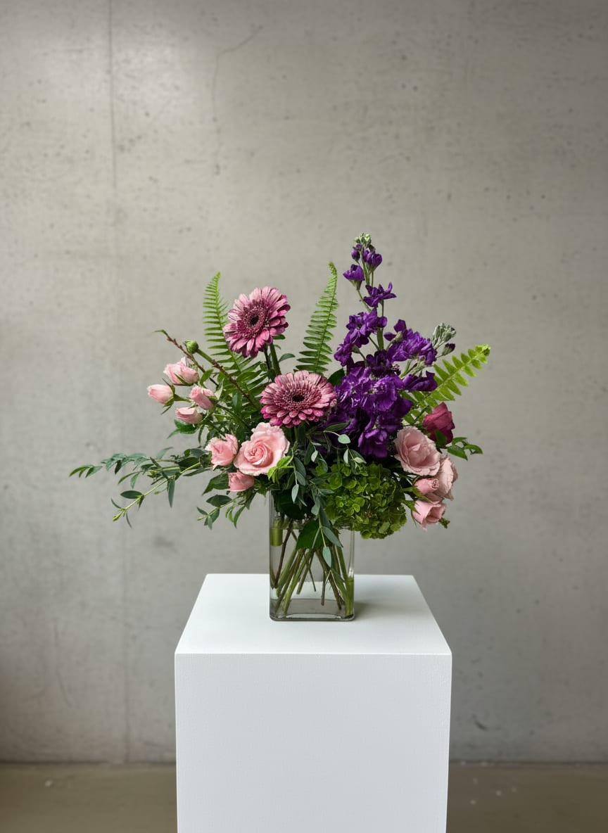 Pink and purple mixed bouquet in a clear glass vase