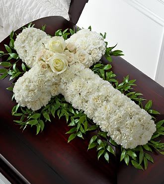 White floral casket spray with roses and greenery