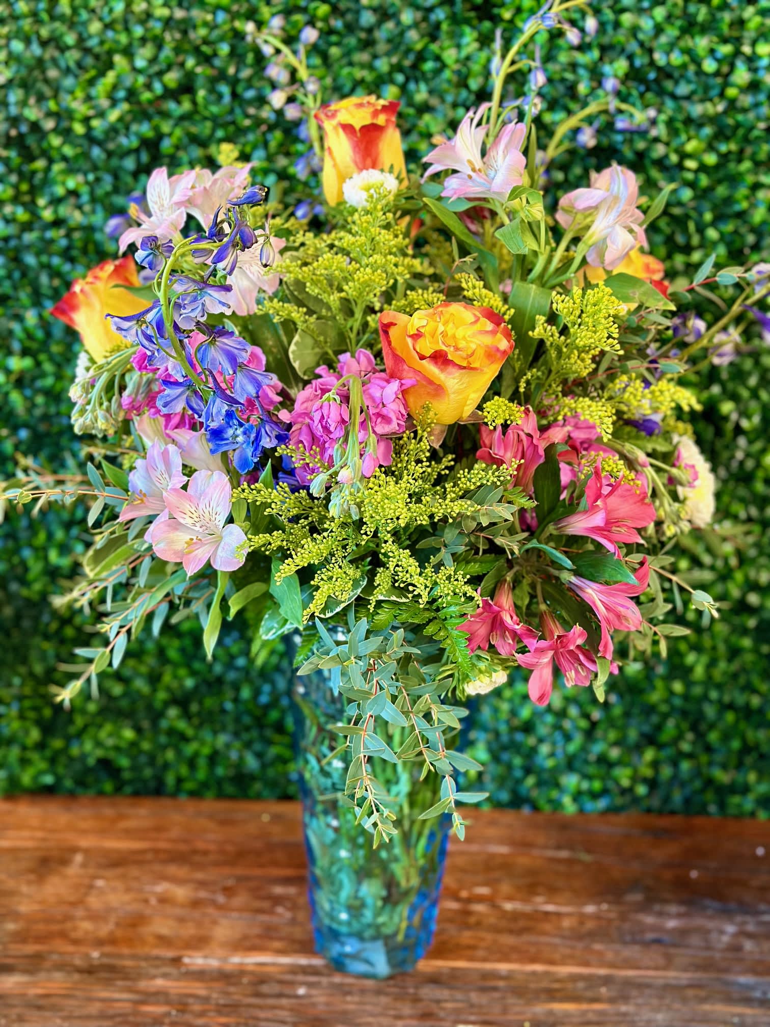 Colorful mixed bouquet in a blue glass vase