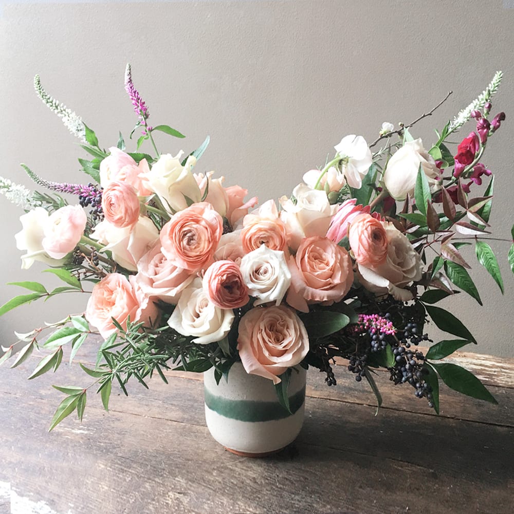 Cadence (Gallery Photo) - A beautiful and soft, peach tone of garden blooms are gathered in a keepsake vase to convey your most loving thoughts. 