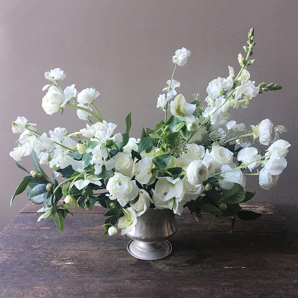 White floral arrangement in a silver vase