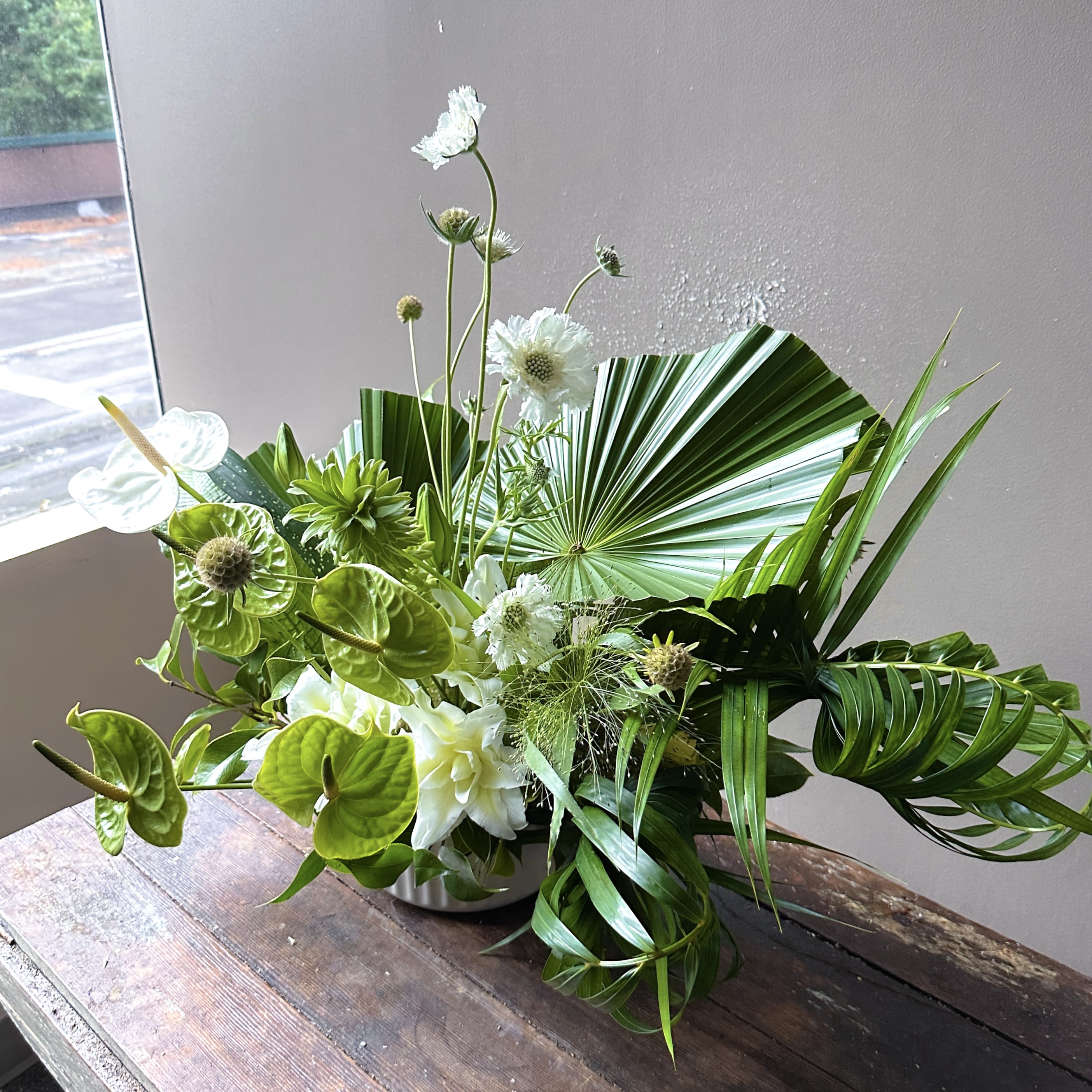Emeraude (Gallery Photo) - A lush green arrangement that captures the essence of botanical dreams! Bursting with vibrant foliage, layered textures, in emerald tones!