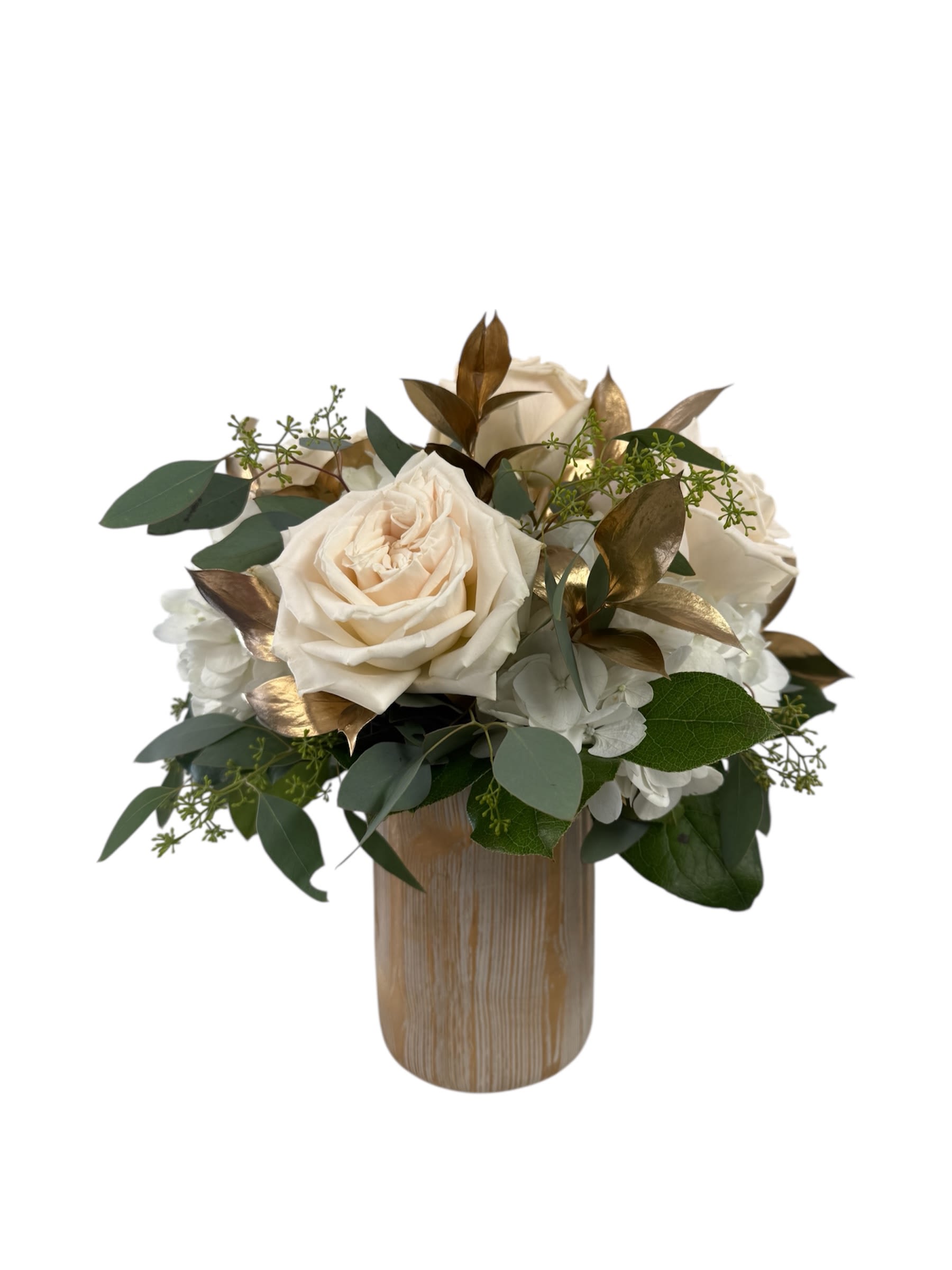 Cream roses in a wooden vase with green foliage