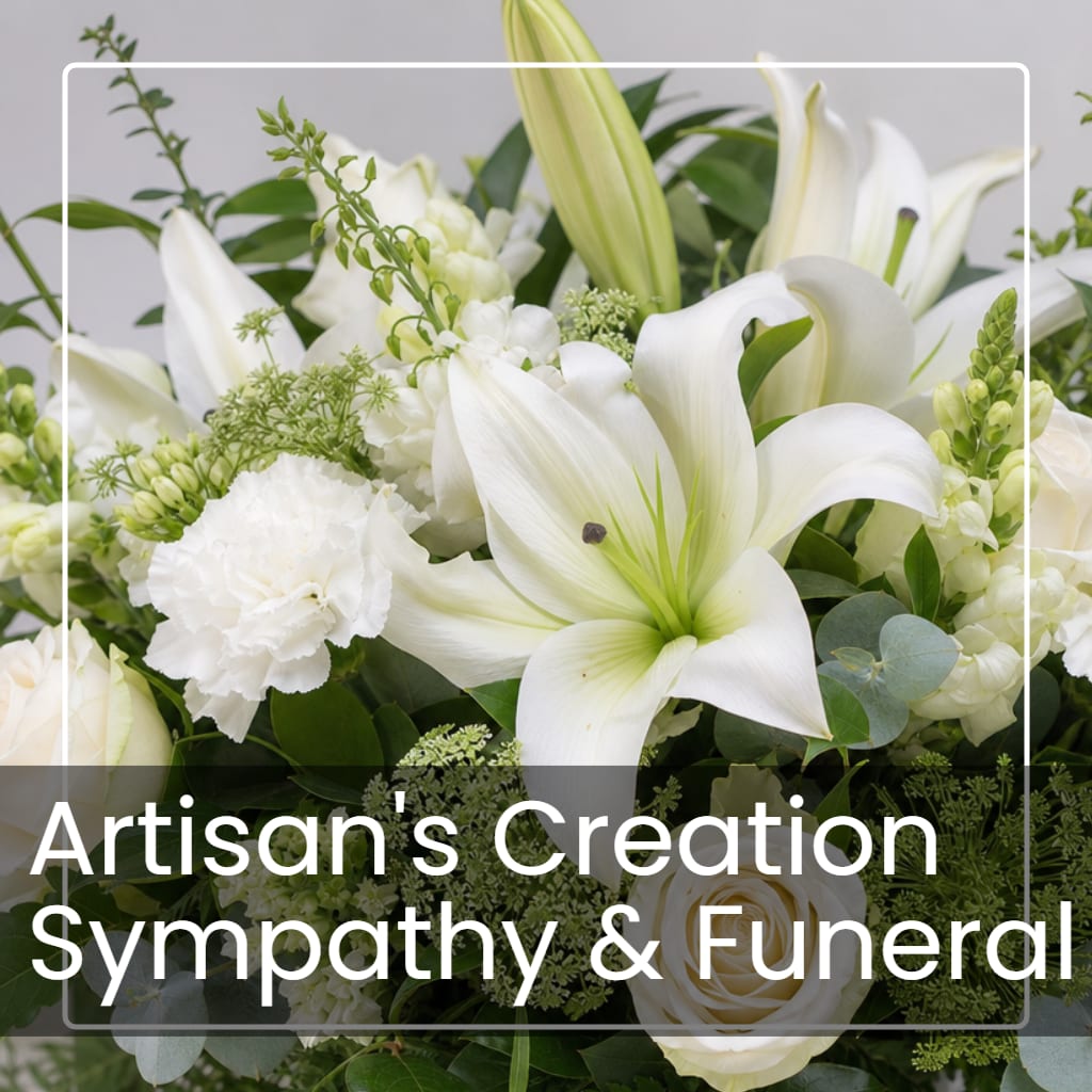 White lilies and roses arranged with greenery in a sympathy bouquet