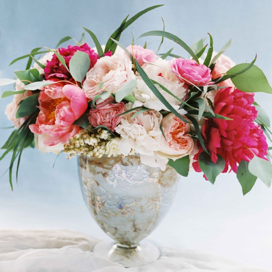 Pink and white flower arrangement in a glass vase