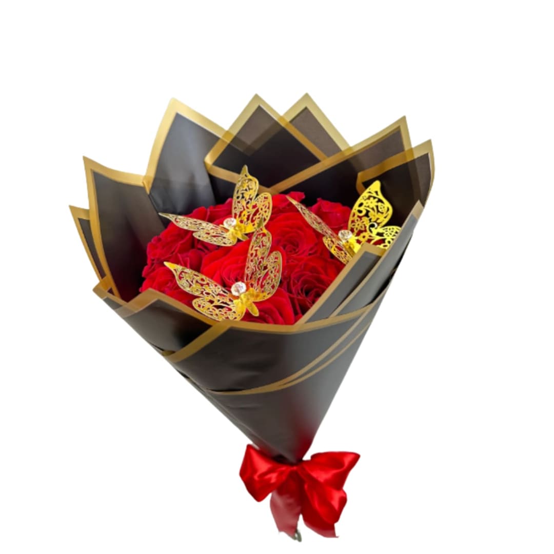 Red rose bouquet wrapped in black and gold paper with a red bow