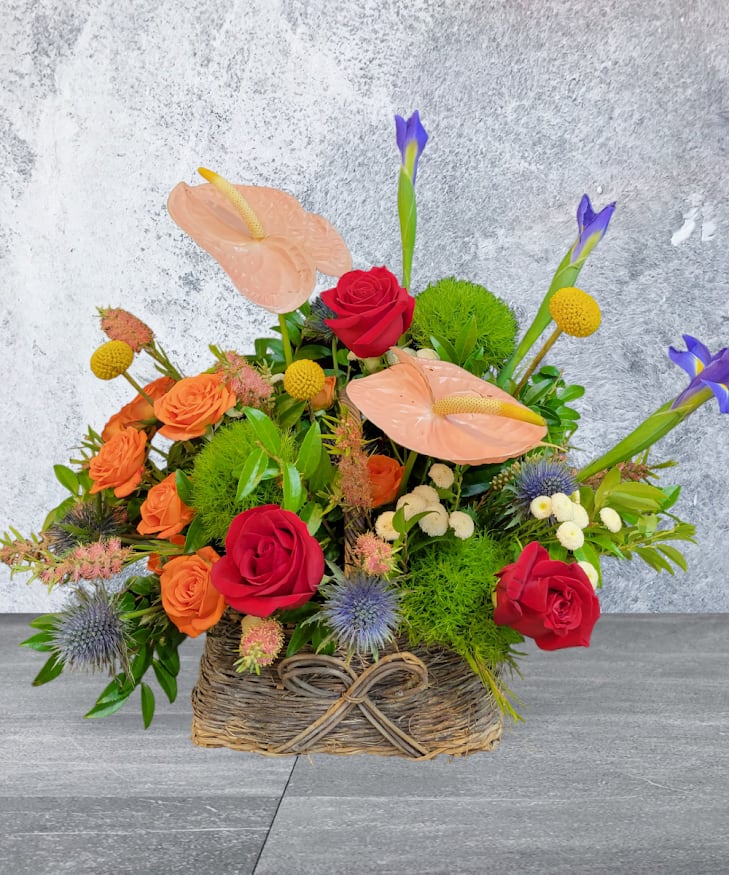 Romantic table Basket - Red Roses, Orange garden roses, Anthurium, Iris arrangements in the Basket 