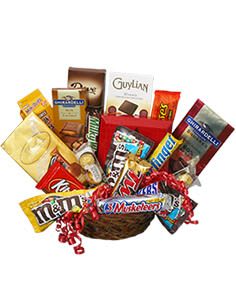 Basket of assorted candy bars and chocolate packages with red ribbon