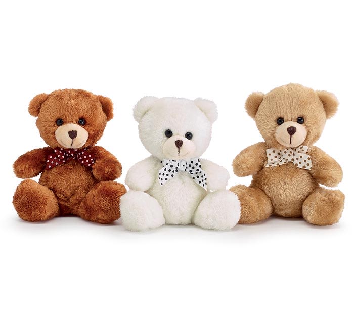 Three plush teddy bears with polka-dot bows on a white background