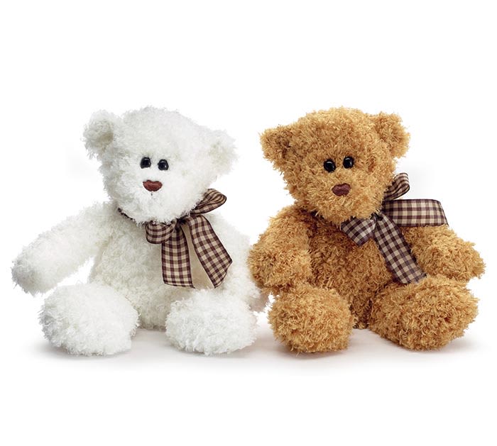 Two teddy bears with plaid bows, one white and one brown