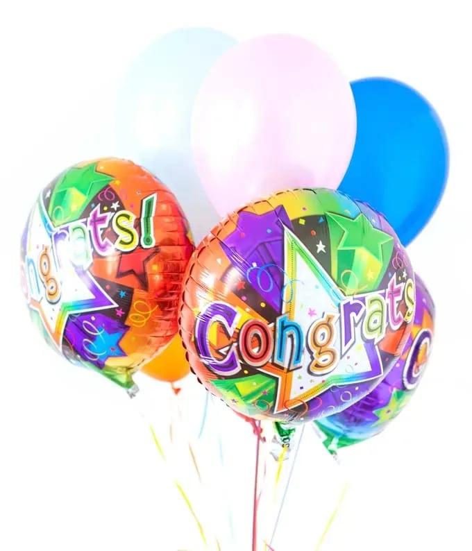 Colorful congratulatory balloons with pastel balloons behind them