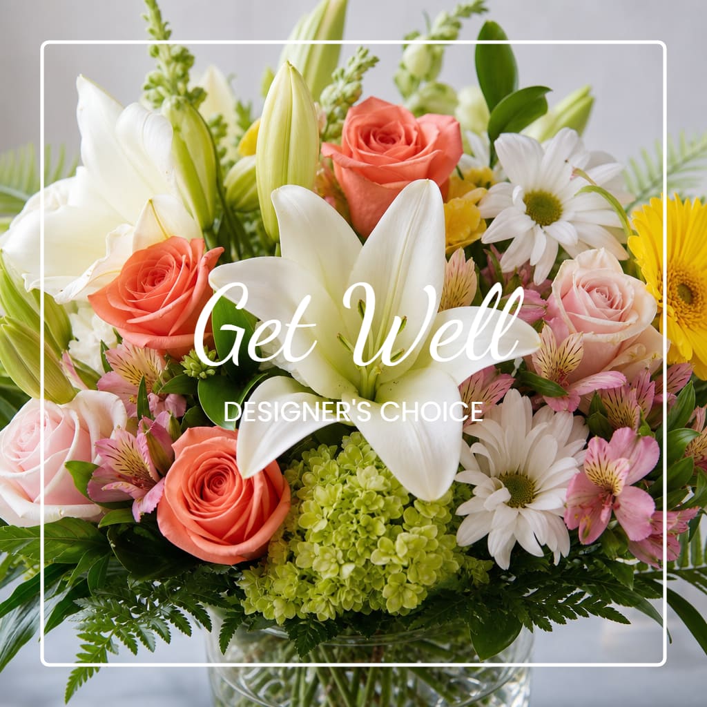 Mixed bouquet with lilies, roses, daisies, and alstroemeria in a glass vase