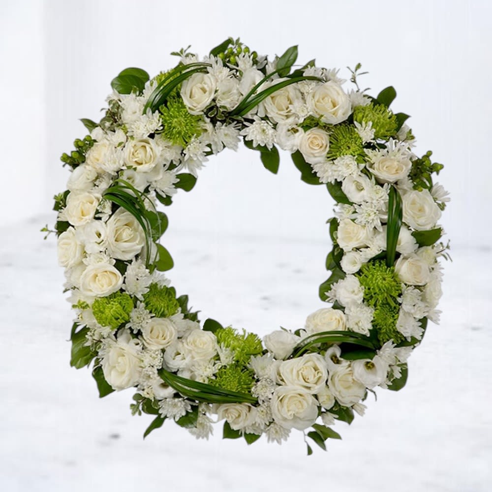 Ingrained Serenity - Ingrained Serenity is a timeless tribute wreath crafted in calming whites and greens. Designed to honor a full life and peaceful passing, this elegant arrangement offers a message of comfort and remembrance. Displayed on an easel for effortless presentation at services, it reflects grace, dignity, and enduring love.