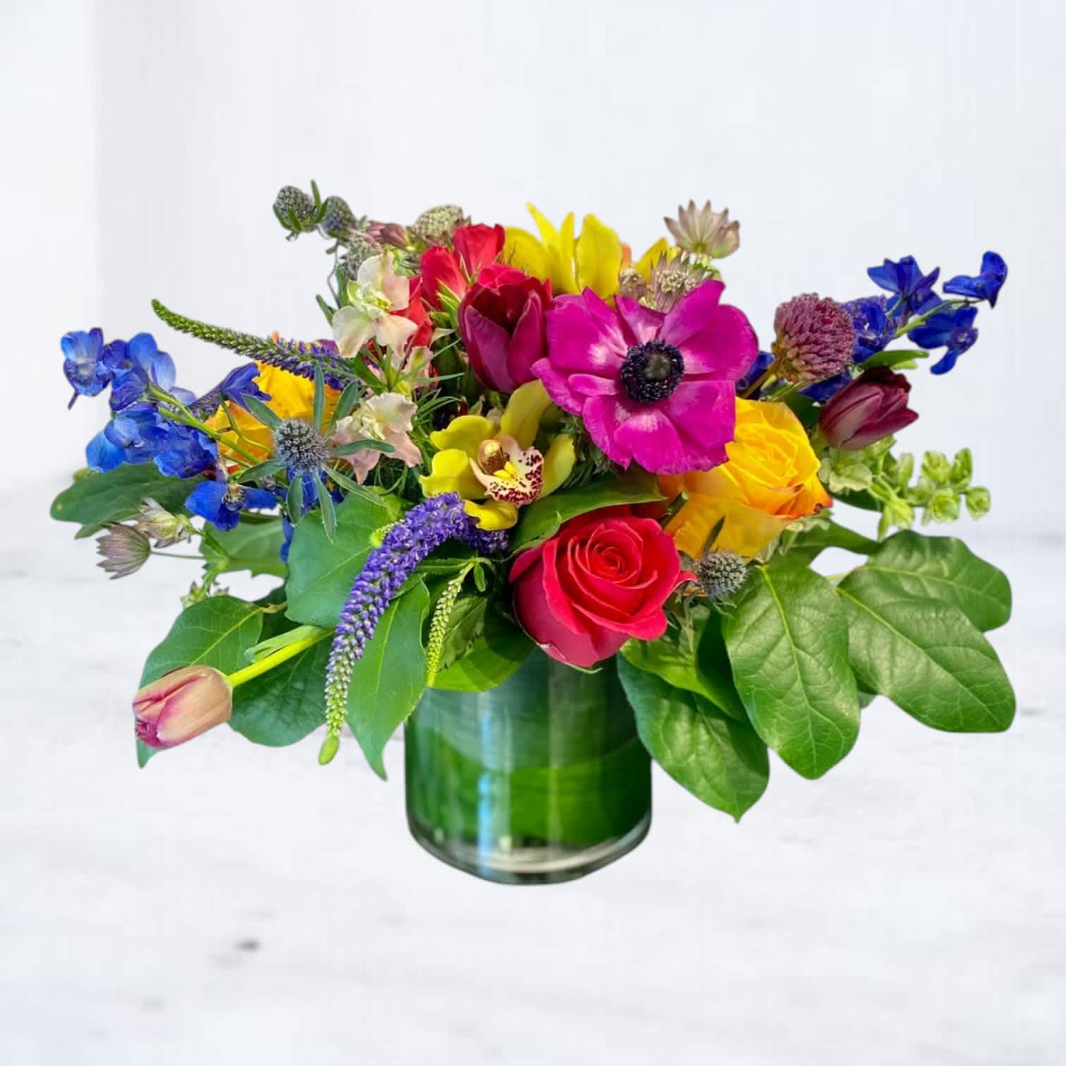 Colorful mixed bouquet in a green glass vase
