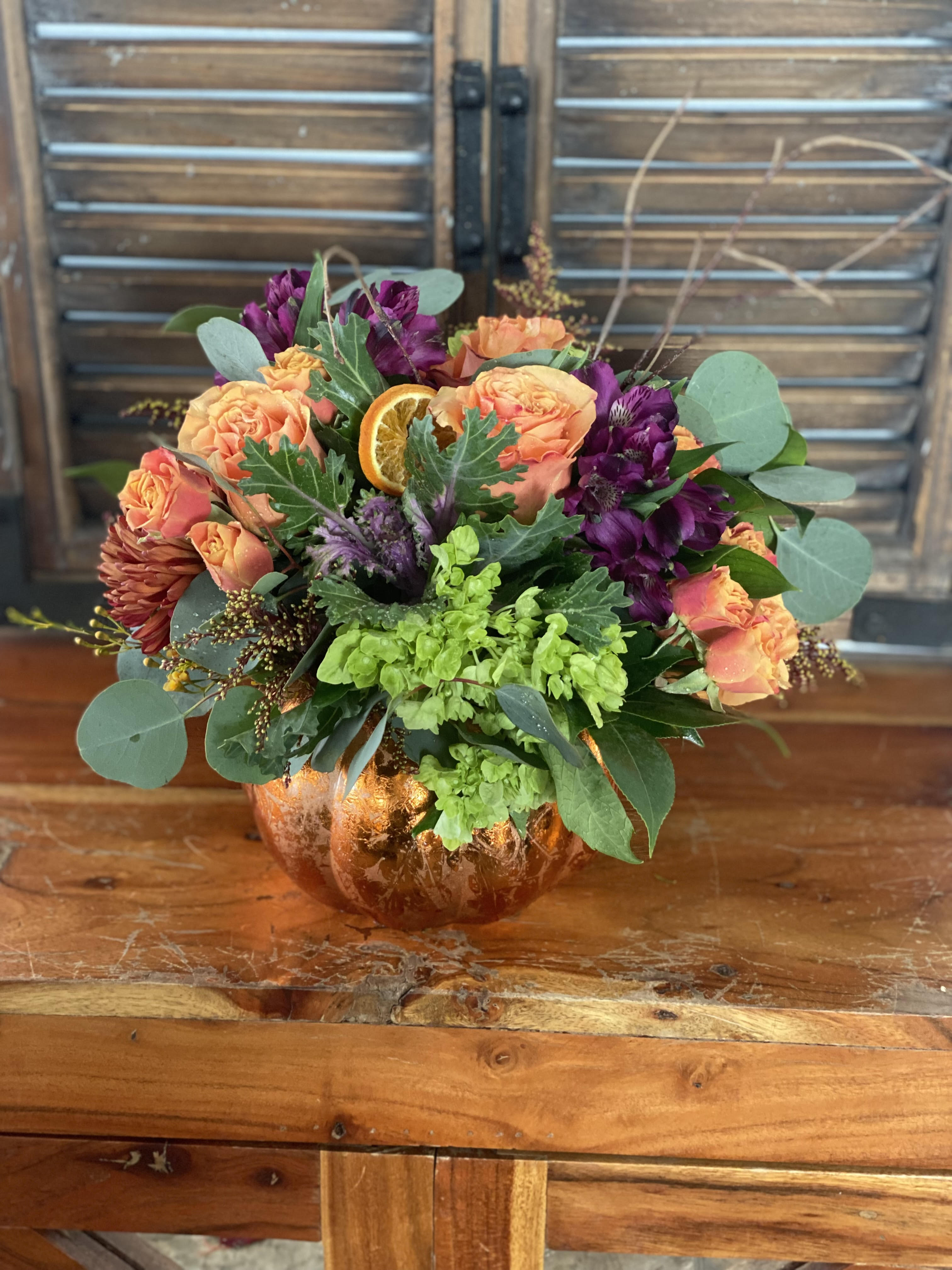 Rise and Shine, it's Fall! - With this arrangement, the sunflower will brighten you up as the pumpkin vase rings in the season. With mini roses, hydrangeas, and daisies this arrangement's splendor is brought front and center. 