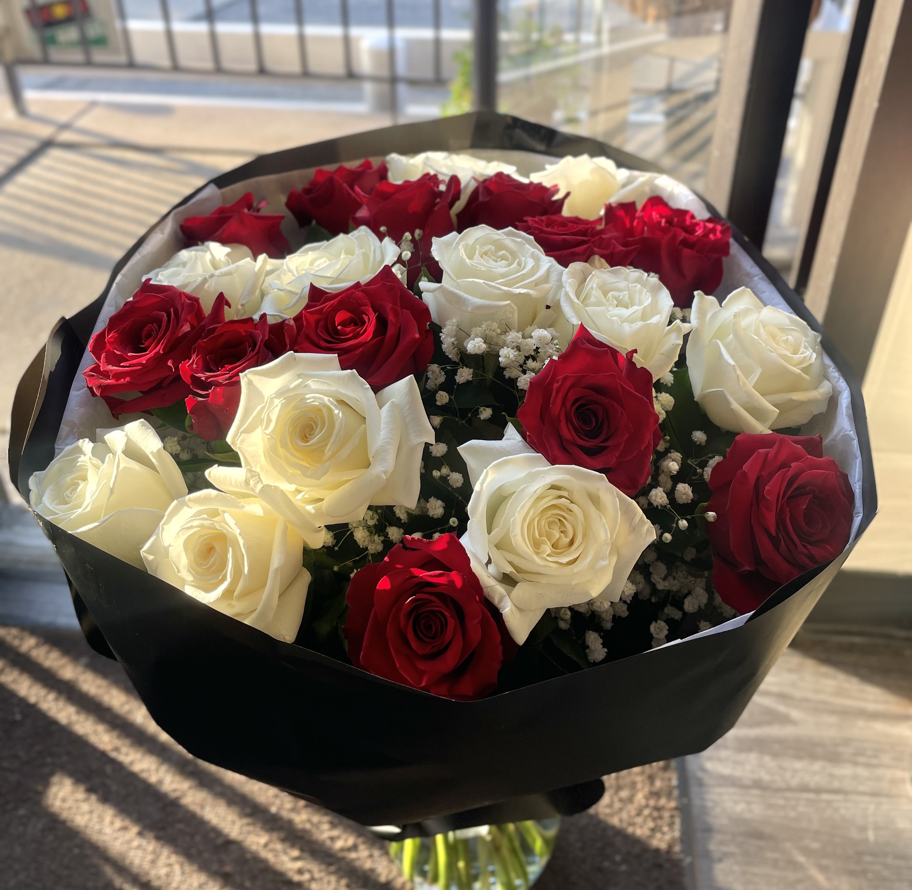 Red and White Roses Bouquet -   Perfect for anniversaries, weddings, or as a thank-you that should feel memorable, this bouquet is the kind of gift that makes someone feel truly seen and celebrated. Available ready-to-display in the included clear vase; trim stems and refresh water as needed to extend bloom life. Wrapped Bouquet Only.
