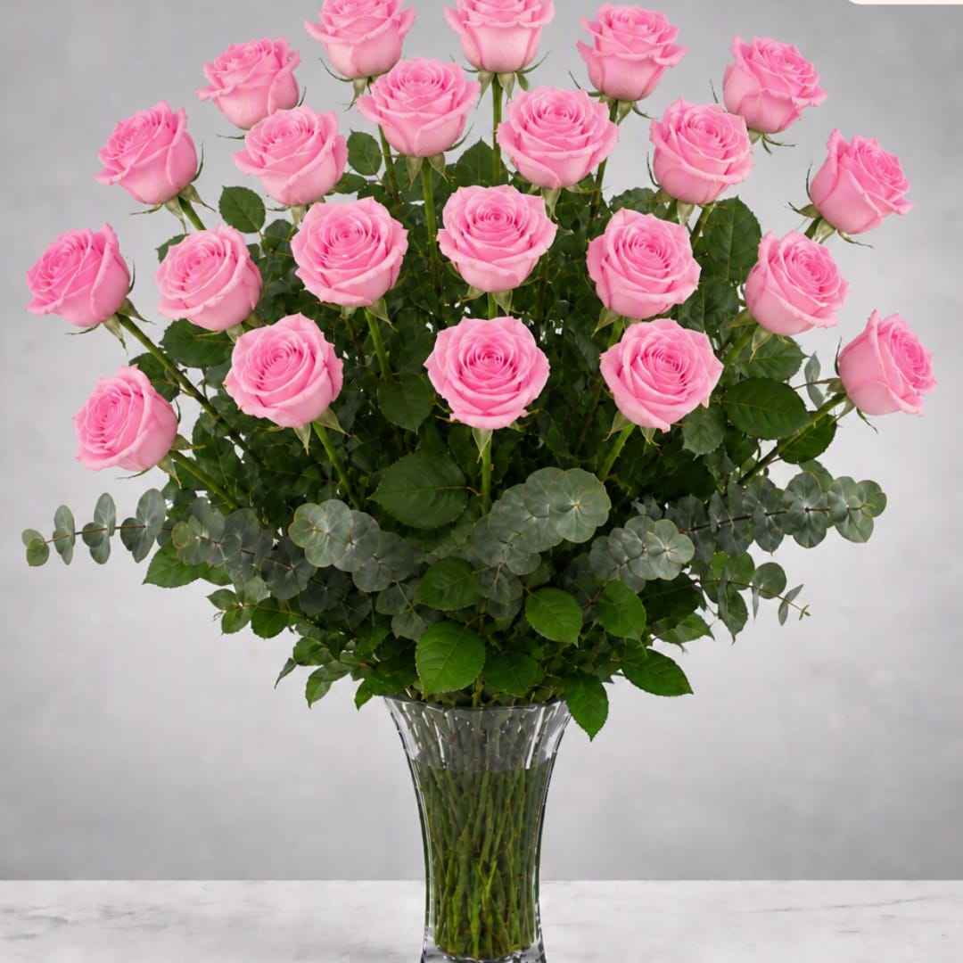 Tall bouquet of pink roses in a clear glass vase