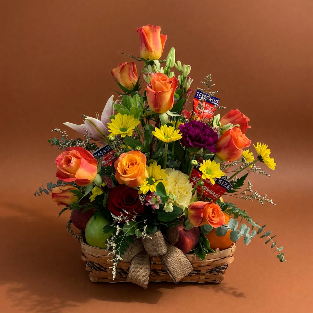 Basket arrangement of orange roses, lilies, and yellow daisies