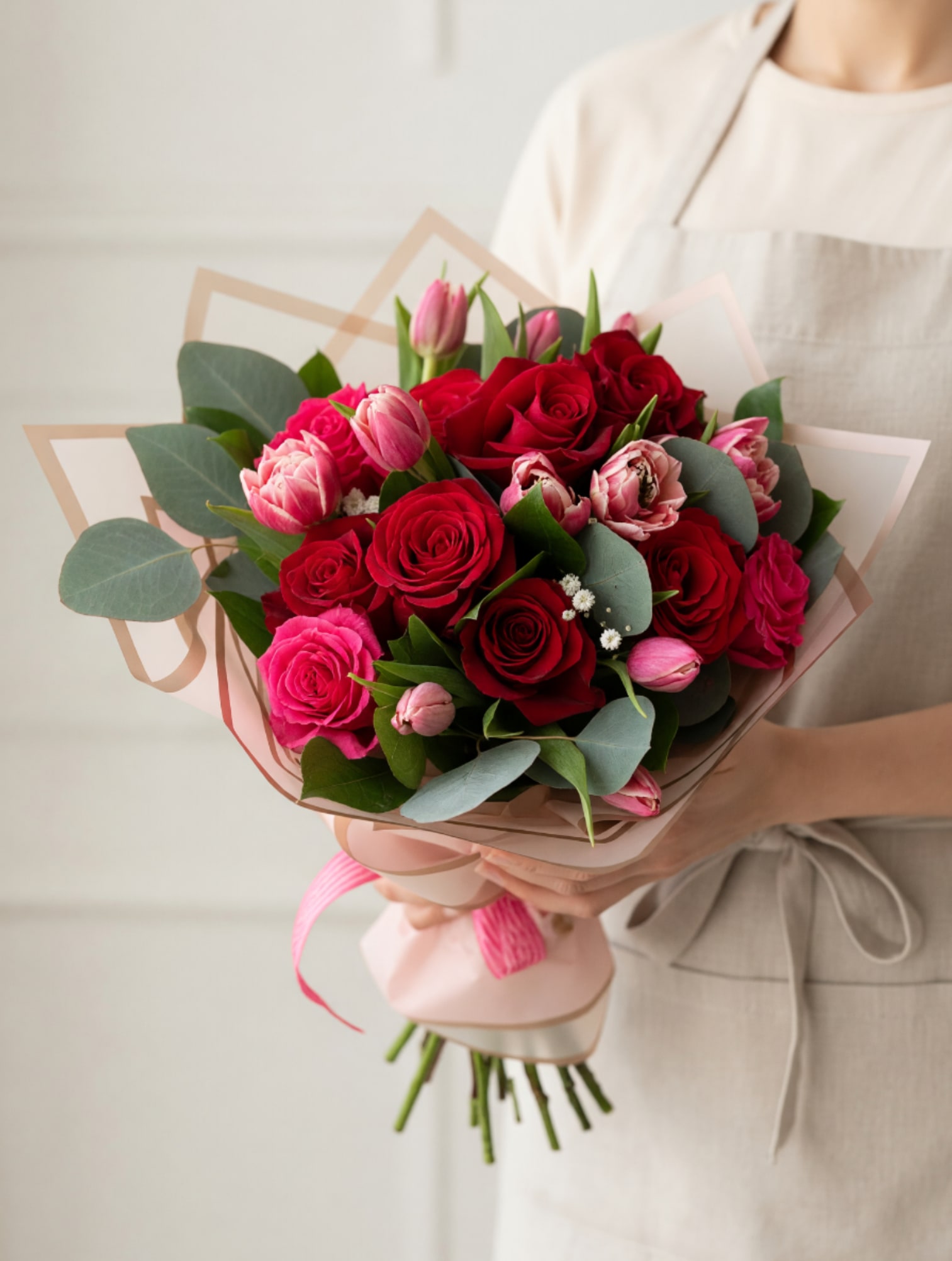  Romantic Mixed Rose &amp; Tulip Bouquet - This elegant bouquet brings together the timeless beauty of lush red roses and the soft charm of pink tulips, thoughtfully arranged with fresh seasonal greenery. Wrapped in white paper and finished with a vibrant pink bow, this design strikes the perfect balance between classic romance and modern sophistication. Ideal for Anniversaries, Birthdays, or Just Because, this bouquet is a heartfelt way to express love, admiration, and appreciation. Each arrangement is handcrafted with care to ensure freshness, beauty, and a lasting impression. Please note: Flower varieties may vary slightly based on seasonal availability, but the overall look and feel will remain true to the design shown.
