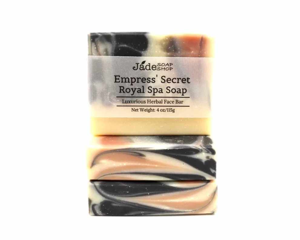 Stack of two marbled cream, black, and peach bar soaps wrapped with an Empress' Secret label.