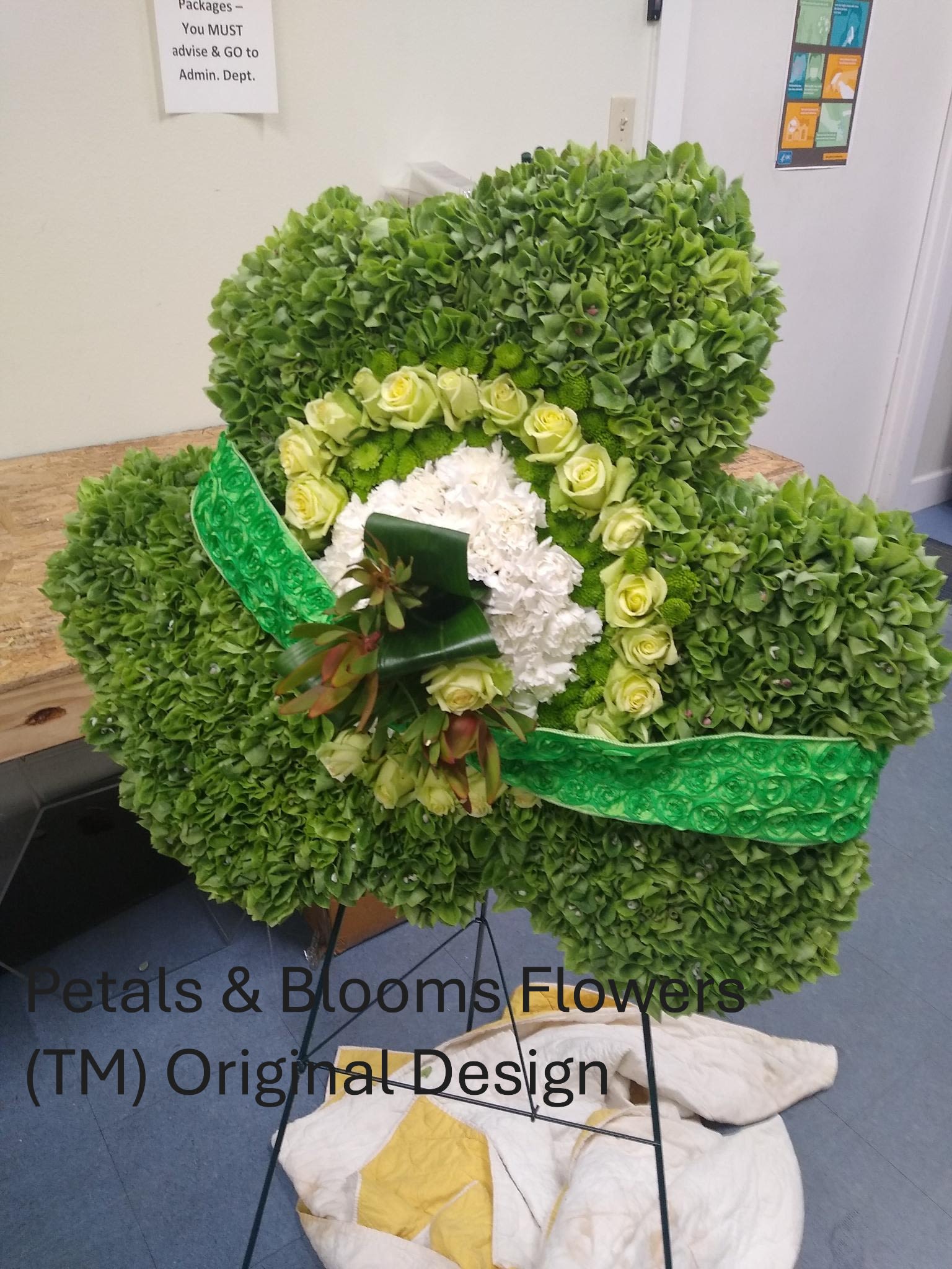 Custom Shaped Funeral Wreath's  - Petals &amp; Blooms Flowers specializes and creates beautiful custom funeral wreaths for your departed's funeral service. As a celebration of their lives, we will design and deliver a beautiful custom wreath that reflects their personal hobbies, interests and spirit. Client's can choose from shamrocks, music, books, wine, sports, and many other personal hobbies and interests that their departed enjoyed and loved while they were living. Our talented team will create that memory in a personalized, custom floral wreath as a memorial to their service.  ***NOTE**** Please email the florist at checkout the shape you would like us to design for your custom floral wreath.  Examples include: Animals, Clubs &amp; Organizations, Sports, Shamrock, Music and any hobby that you know the departed personally enjoyed. The florist will email you with any questions.  ***NO SIZE REQUESTS AS ALL CUSTOM WREATHS ARE DESIGNED TO OUR Internal company STANDARD SIZES** ***NO SPECIFIC FLOWER REQUESTS ACCEPTED FOR THIS PRODUCT- FLORIST CHOOSES ALL FLOWERS AND GREENS*** Clients are permitted to email florist their color choices All wreaths are presented on an easel at the service PLEASE ALLOW UP TO 5 Business days for ordering a custom wreath