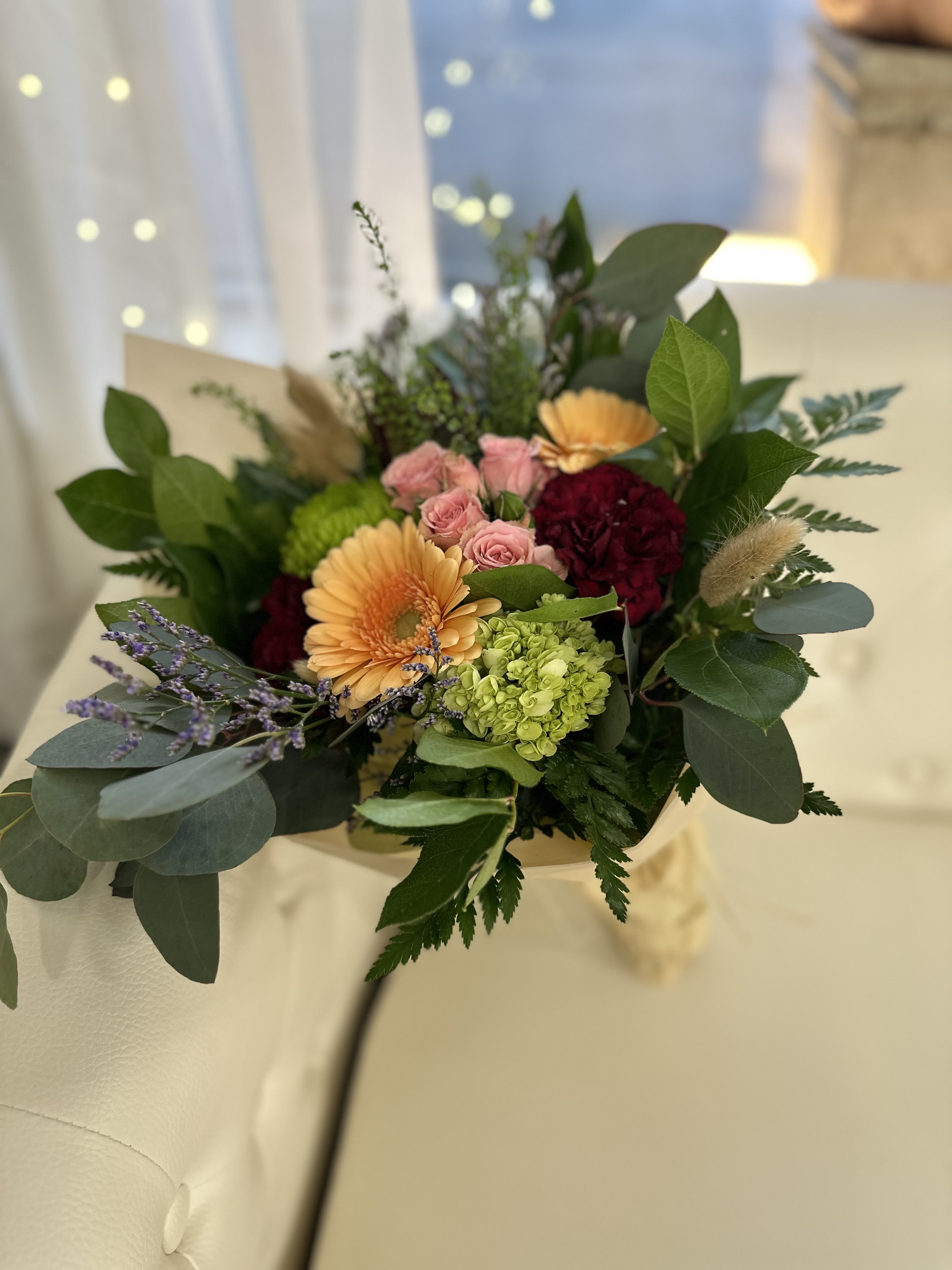 Grab-n-Go Bouquet by Westford Florist Art by Veny - Looking for a beautiful and budget-friendly bouquet on the go? Look no further than the Grab-n-Go Bouquet by Westford Florist Art by Veny. This stunning arrangement features a mix of gerberas, spray roses, mini green hydrangeas, carnations, and sea lavender - guaranteed to make a great impression every time. Please note that while the flowers in this bouquet may vary from day to day, you can trust that our skilled florists will always create a gorgeous arrangement for you. Simply place your order online and pick it up at our store. Please keep in mind that images are for reference only. The actual bouquet will differ based on flower availability and season. Order yours today and bring home some floral joy!