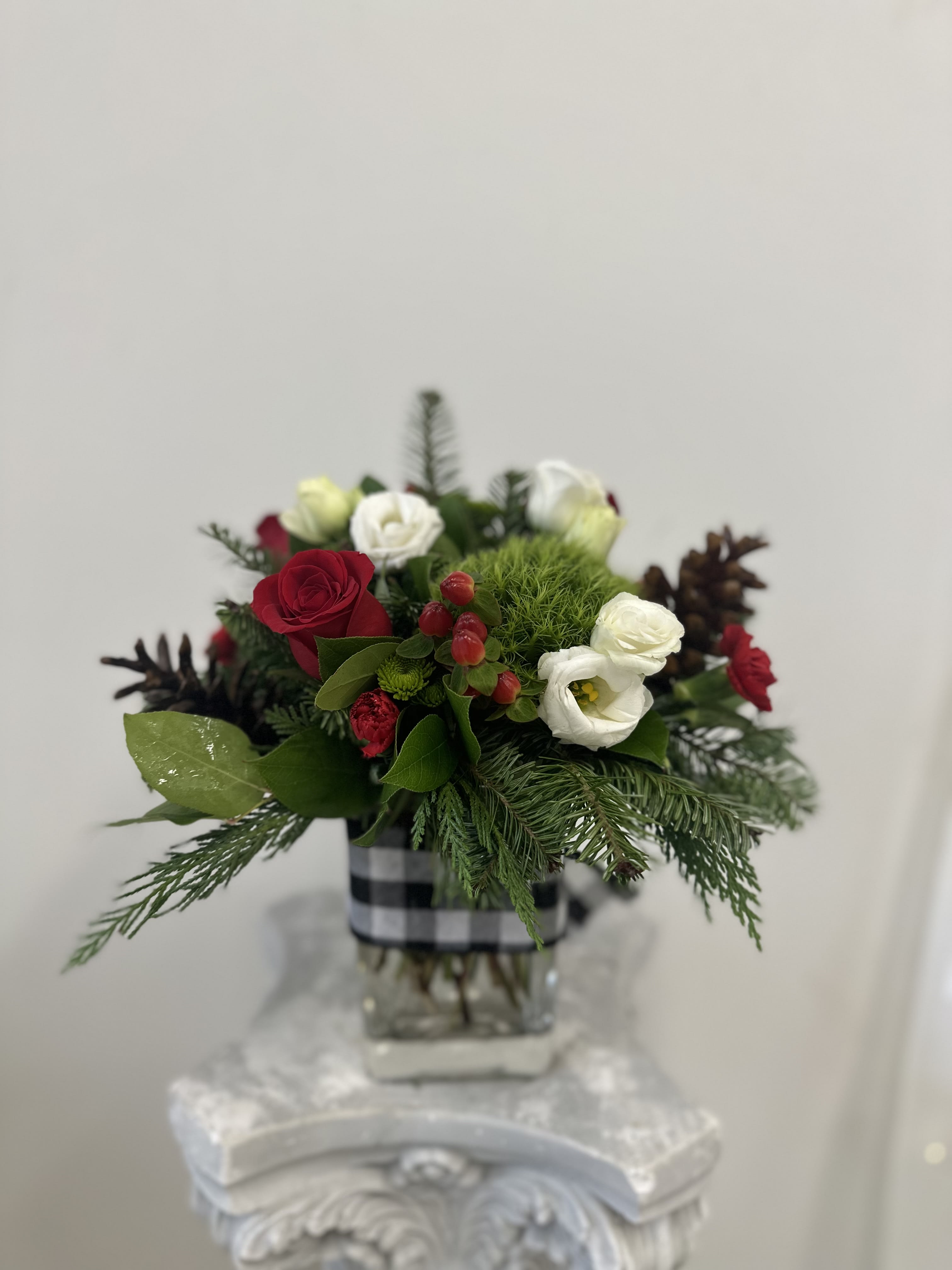 Magic of the Season by Westford Florist Art by Veny - Capture the essence of the season with "Magic of the Season" by Westford Florist Art by Veny. This exquisite arrangement brings together a stunning blend of vibrant red roses, delicate white lisianthus, and playful mini carnations, complemented by lush green trick and unique safari sunset foliage. Each bloom is thoughtfully curated to embody the warmth and joy that this time of year inspires. A perfect gift for loved ones or a special treat for yourself, this enchanting bouquet will brighten any space and create cherished memories. Embrace the magic—celebrate the spirit of joy today!
