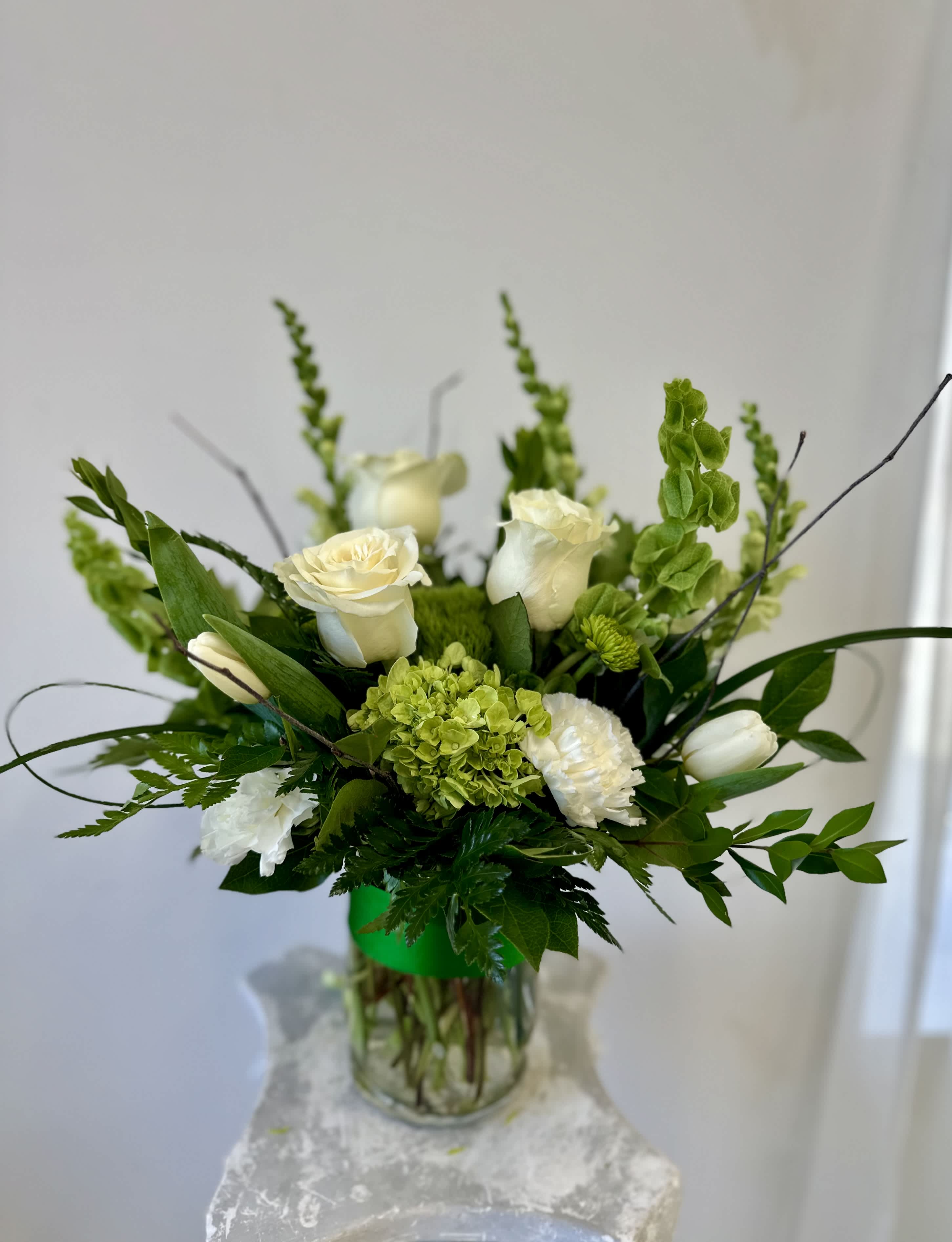 St. Patrick's Day flowers By Westford Florist Art by Veny - Celebrate the spirit of St. Patrick's Day with enchanting St. Patrick's Day Delight Arrangement by Westford Florist Art by Veny! This vibrant, hand-crafted floral masterpiece is perfect for sharing good cheer and warm wishes with loved ones—whether it’s family, friends, or that special someone who could use a little festive joy in their day. Designed to brighten any space, this delightful centerpiece features an array of blooms that evoke the rich colors of emerald green and golden sunshine—just like the holiday itself! Plus, we’re offering it at a fantastic value because everyone deserves a splash of greenery this season. Let your heartfelt message shine through as you send smiles and laughter along with these beautiful blooms. Perfectly hand-delivered right to their door, making it easy for you to spread happiness without breaking the bank! So go ahead—wish someone a “Happy St. Patrick’s Day” today with our delightful arrangement! 