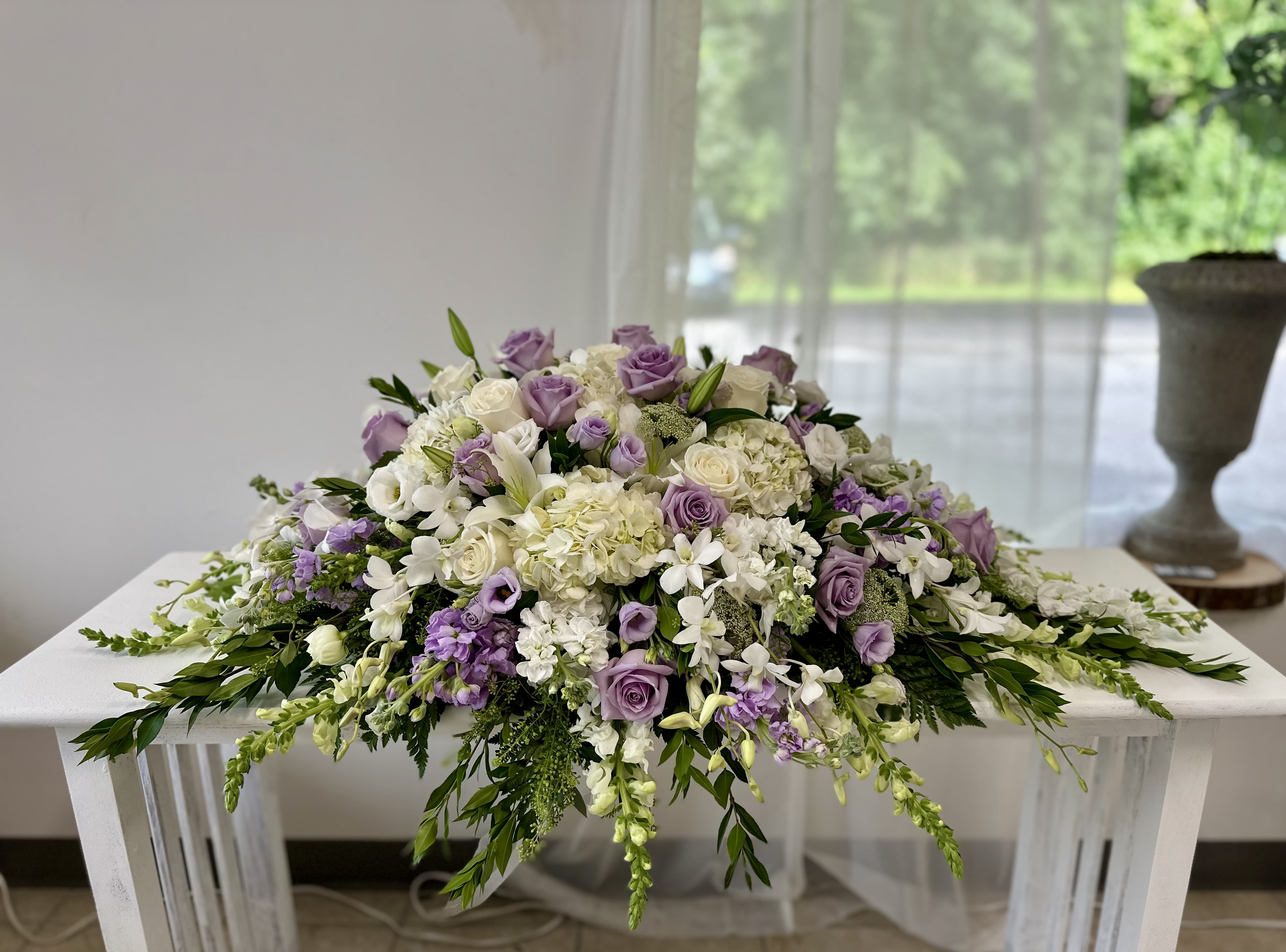 Lavender and white floral arrangement spread across a table
