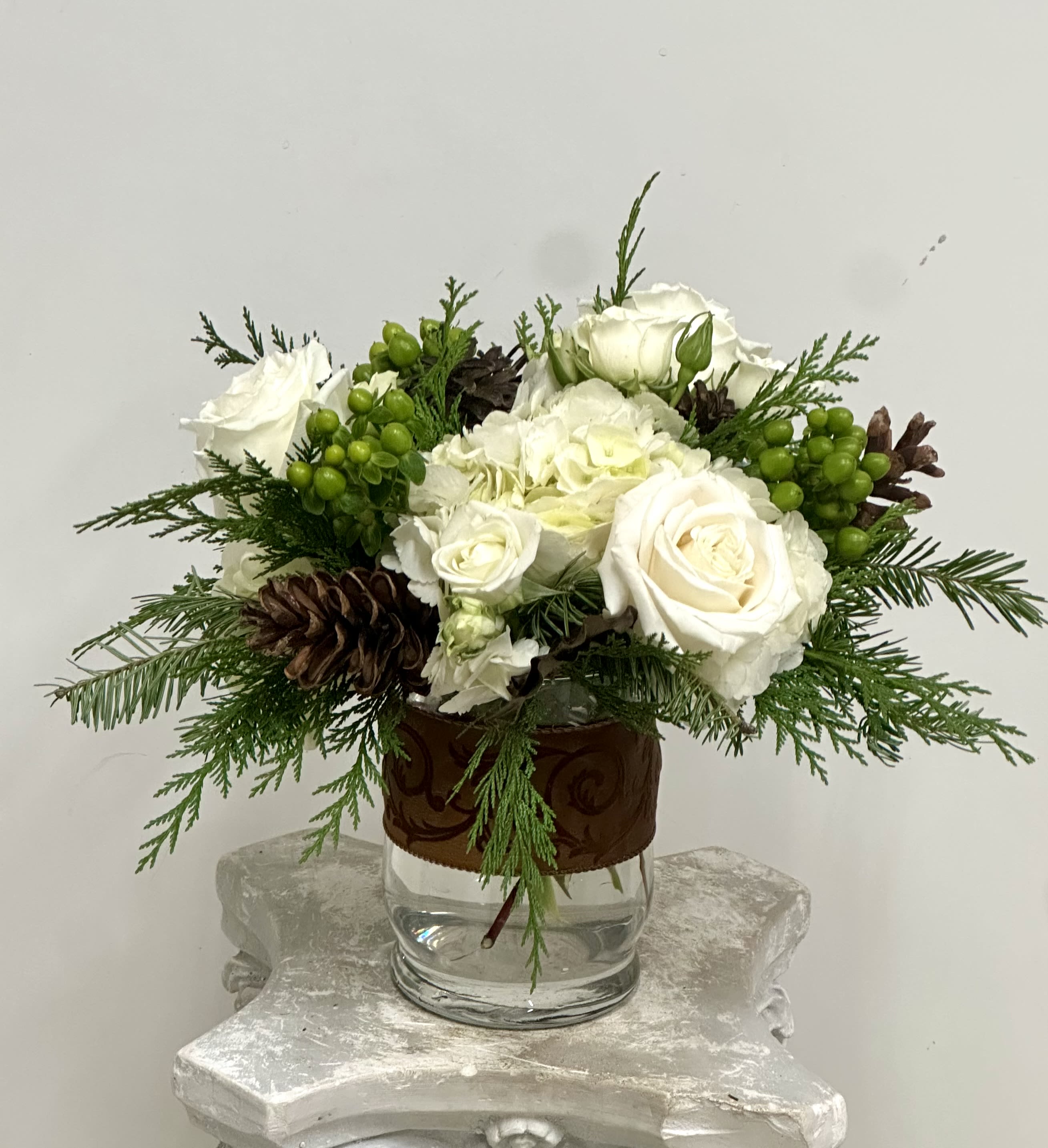 Winter Garden Delight by Westford Florist Art by Veny - Bring a touch of winter magic into your home with the Winter Garden Delight from Westford Florist Art by Veny! This enchanting arrangement features a stunning blend of white hydrangeas, elegant white roses, and charming spray roses, all nestled among vibrant green hypericum and lush Christmas greens. Perfect for brightening up chilly days or adding a festive flair to your holiday gatherings, this bouquet is like a cozy hug in floral form. Elevate your space or spoil someone special—this delightful creation is just the thing to spread warmth and joy this season!