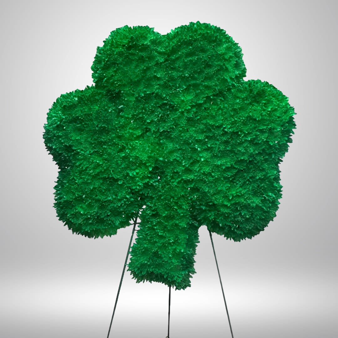 Standing shamrock-shaped spray of dense green flowers on a metal easel