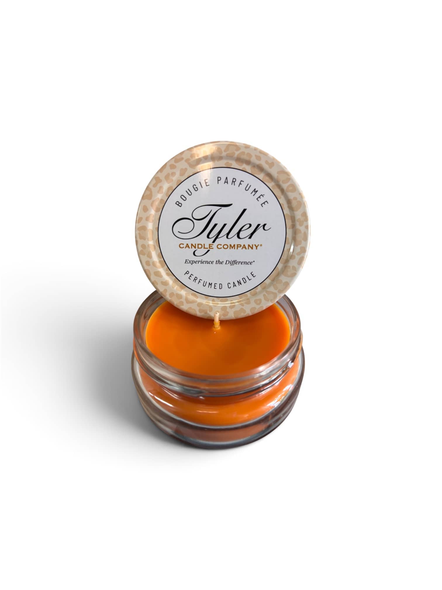 Orange scented candle in a glass jar with a leopard-print lid