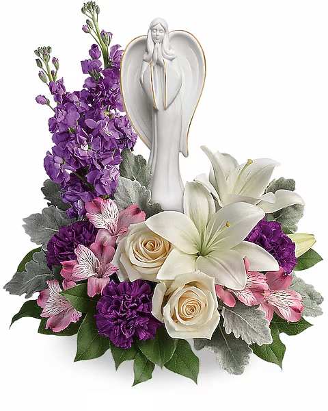 Purple and white floral arrangement with an angel figurine centerpiece