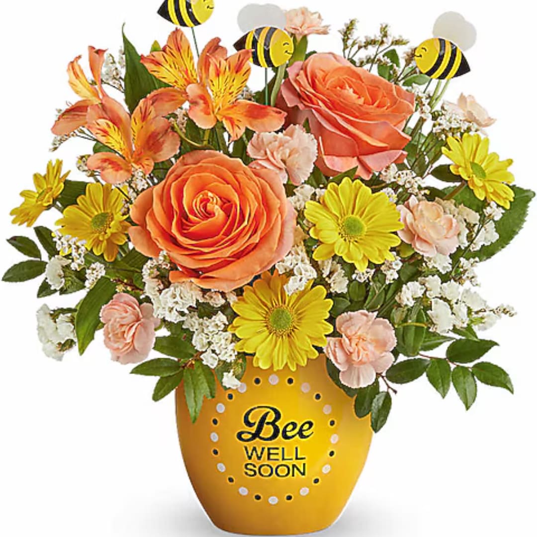 Bouquet of orange and yellow flowers in a bee-themed vase
