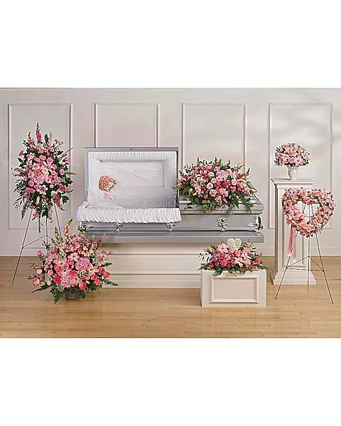 Pink floral funeral set with casket spray, standing sprays, and wreaths