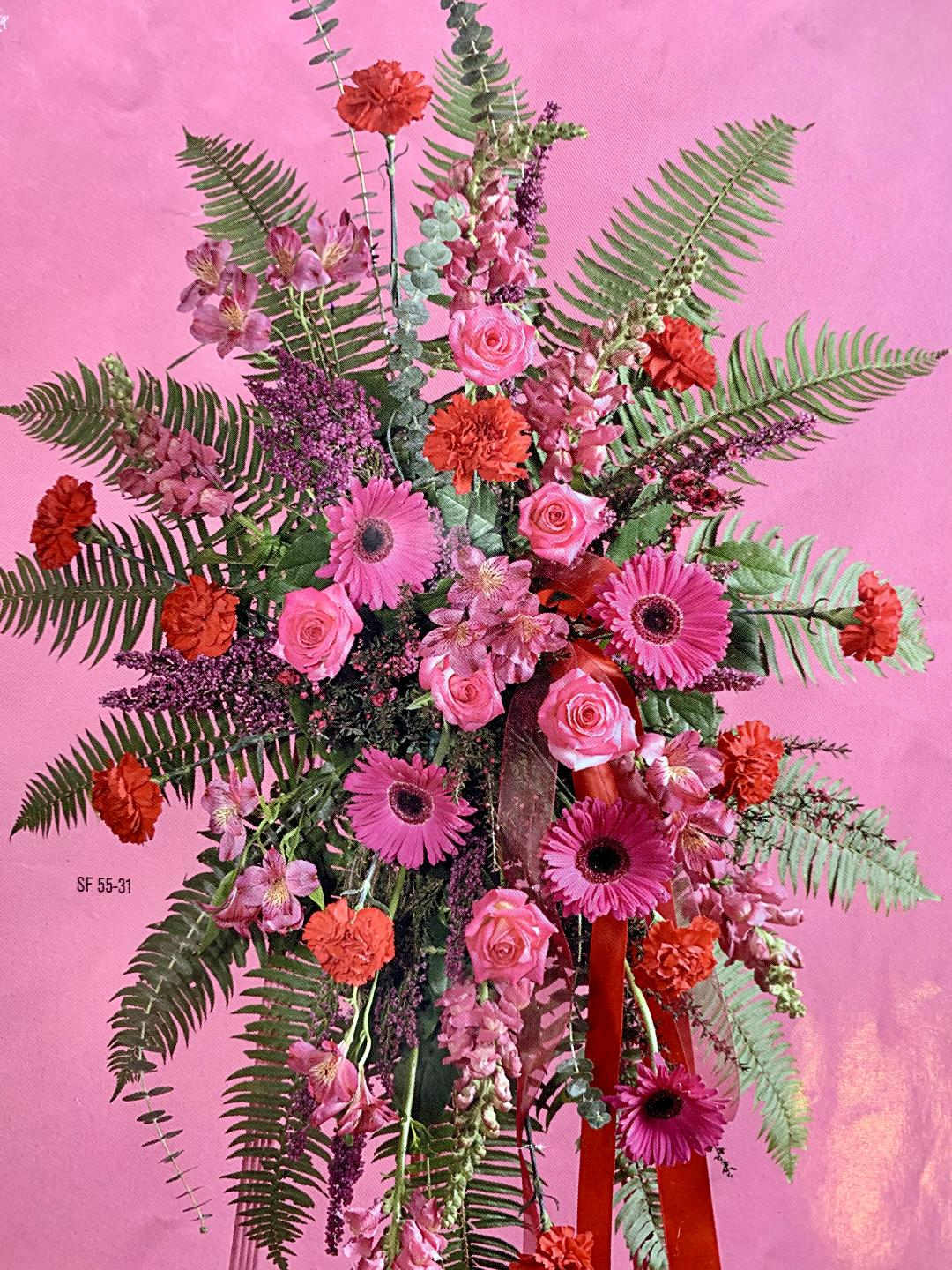 Pink and orange floral arrangement with gerbera daisies and roses