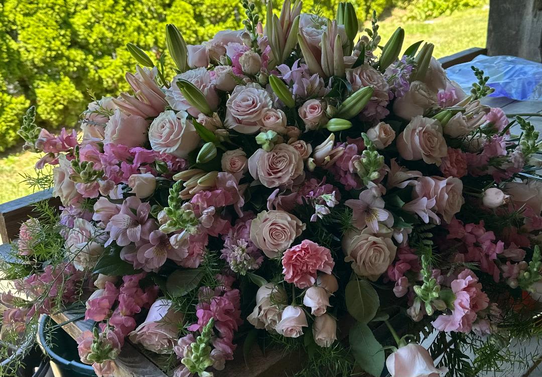 Large bouquet of pale pink roses and lilies with pink filler flowers