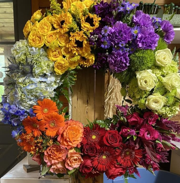 Colorful floral wreath with roses, gerbera daisies, and hydrangeas