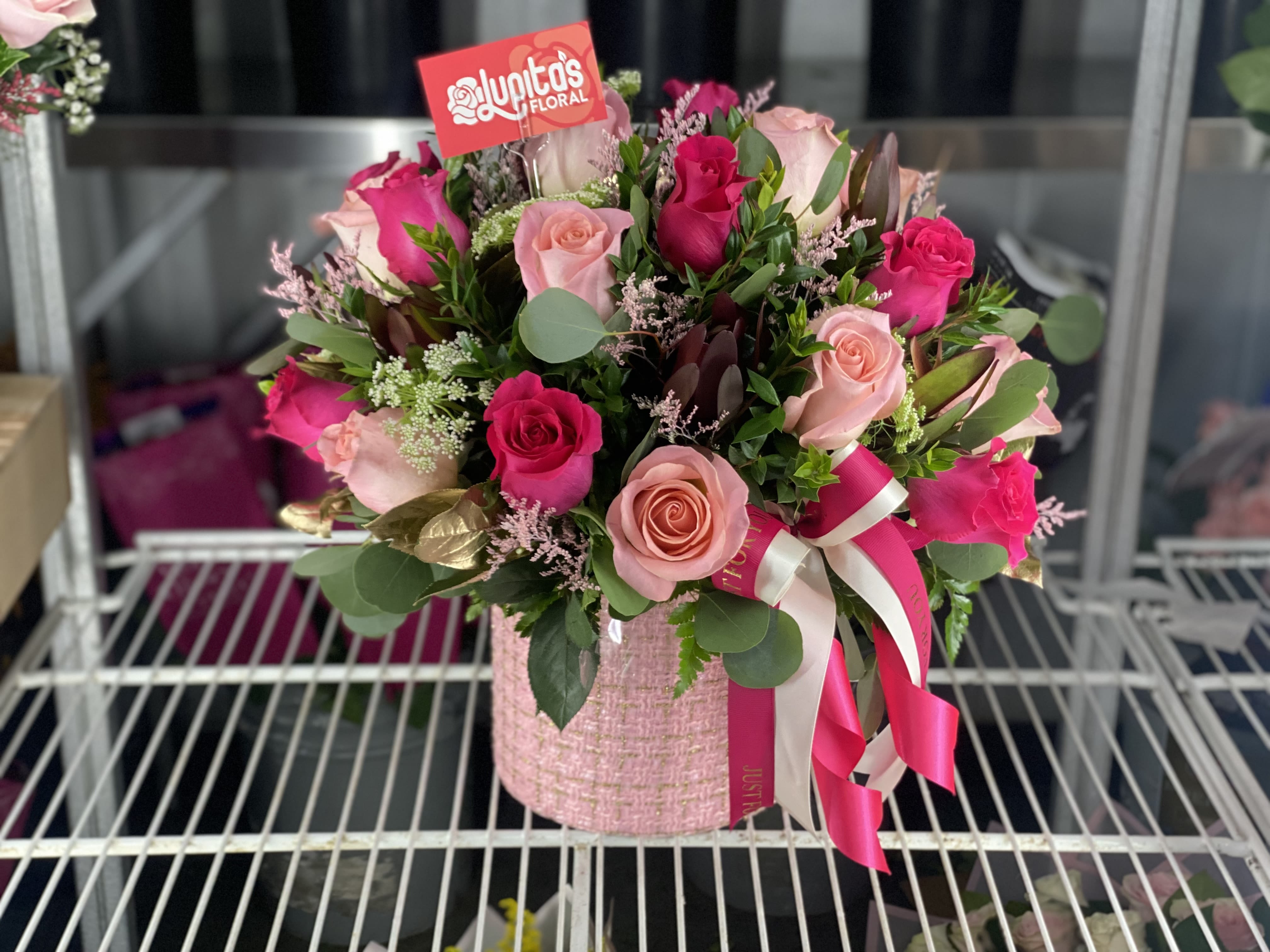 Pink and magenta rose bouquet in a pink textured box with ribbon