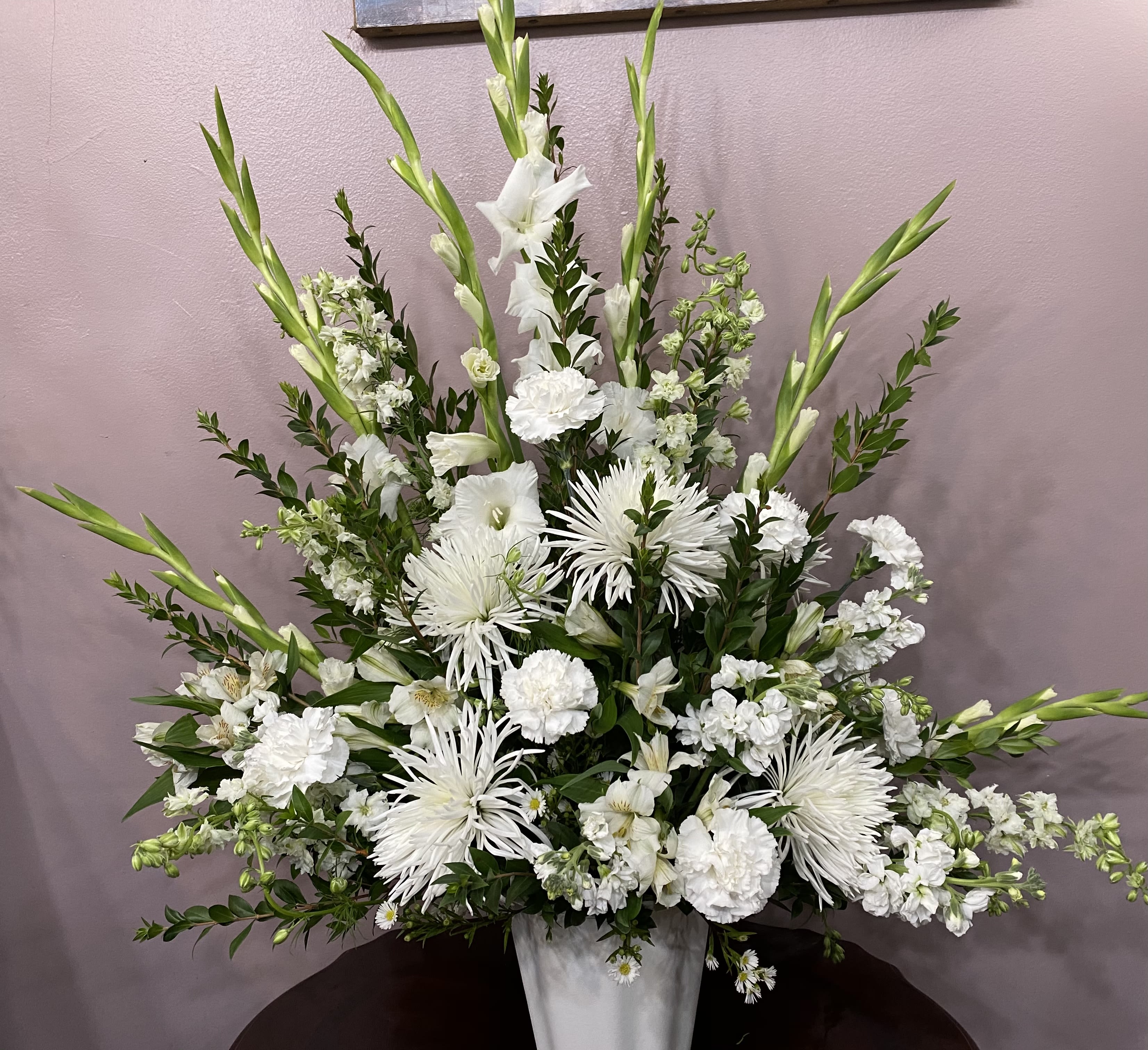 Pure Whites - A beautiful display of all white flowers – including such bright blossoms as gladioli, carnations and stock – will show your thoughtfulness and sentimentality. It’s as clean and pure as a fresh winter snowstorm.