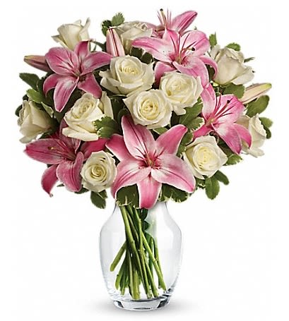 Pink lilies and white roses in a clear glass vase