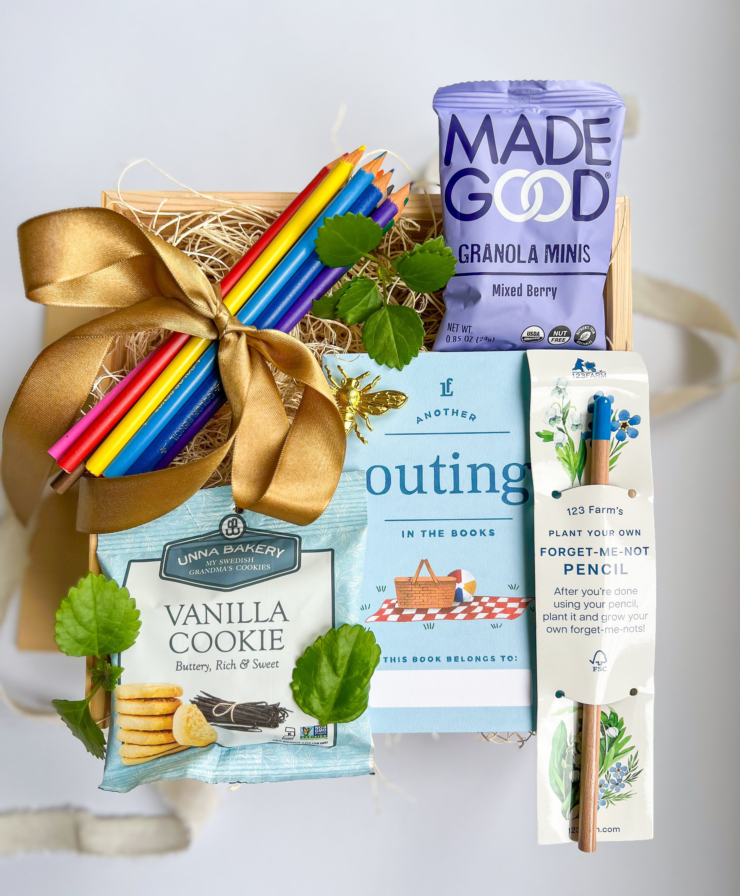 Just for Kids Gift Box  - This gift box includes:  Colored pencil set, Vanilla cookie bag, Another Outing booklet, Granola Minis, Forget me not Pencil (can plant afterwards), 1 Bee Magnet, Wooden keepsake box and a handwritten card.